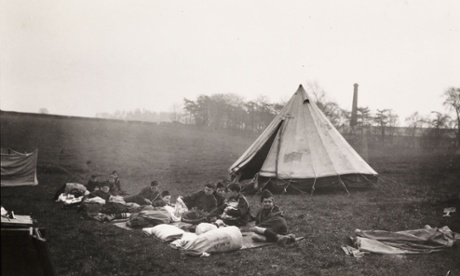 Boy Scouts camping in a field, taken by an unknown photographer, circa 1920.