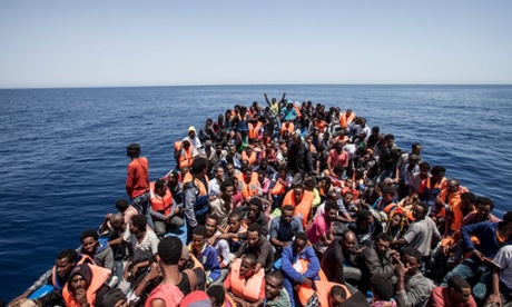 Migrants crowd the deck of their wooden boat off the coast of Libya.