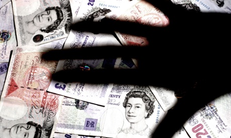 shadow of hand over bank notes