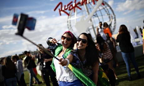 Festival goers in Las Vegas use a selfie stick.