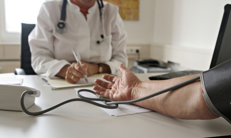 A GP takes a patient’s blood pressure