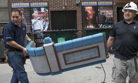 Stagehands carry set materials from the Late Show with David Letterman outside the Ed Sullivan Theater in Manhattan.