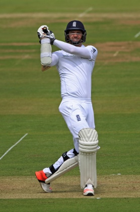 Jimmy Anderson hits a boundary.