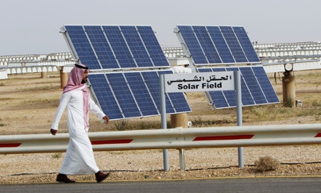 A Saudi man walks on a street past a field of solar panels at the King Abdulaziz city of Sciences and Technology in May 2012.