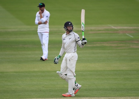 Martin Guptill raises his bat after reaching a half century.