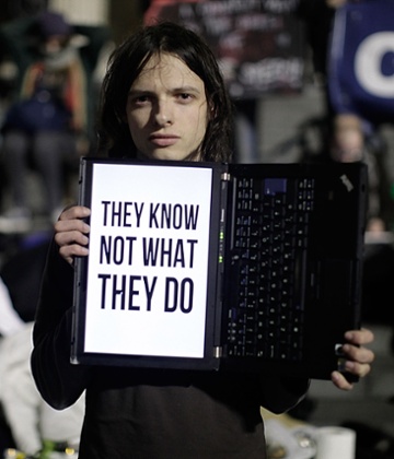 Demonstrators watch as bailiffs, with police as backup, move in to clear the Occupy camp on 28 February 2012.