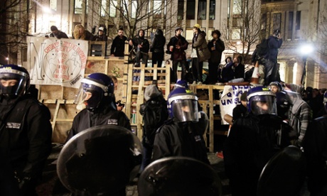 Occupy protesters stand on a barricade outside St Paul's Cathedral in a bid to prevent their eviction.