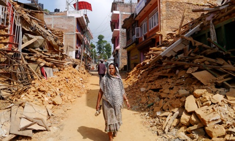 A woman walks along the ruined streets of Chautara municipality, Sindhupalchok district.