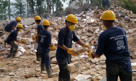 Workers clear the ruins of a government building in Chautara municipality, where nearly 3,500 people were killed and 4,000 injured in the Nepal earhquakes.