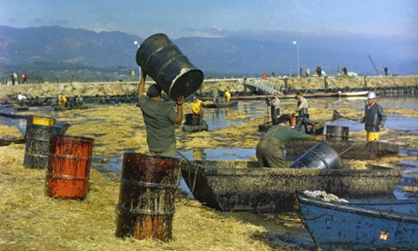 FILE - In this Feb. 7, 1969 file photo, workmen using pitchforks, rakes and shovels attempt to clean up oil-soaked straw from the beach at Santa Barbara Harbor, Calif., used to absorb oil from a week-long leak from an off-shore well which covered local beaches and threatened many others on the southern California shoreline areas. Now in the week of April 20, 2009, lawmakers begin hearings on an energy and global warming bill that could revolutionize how the country produces and uses energy, and could for the first time reduce the pollution responsible for heating up the planet. (AP Photo, FILE)aftermath clean up coast crude disasters ecology environmental disasters offshore drilling oil spills water pollution