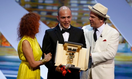 Colombian director Cesar Augusto Acevedo (C) poses after being awarded with the Camera d'Or for his film 