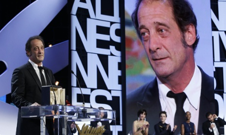 Actor Vincent Lindon stands on stage after receiving the Best Actor award for the film The Measure of a Man during the awards ceremony at the 68th international film festival, Cannes, southern France, Sunday, May 24, 2015. (AP Photo/Lionel Cironneau).
