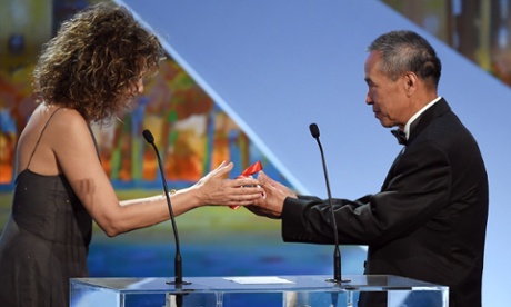 Taiwanese director Hou Hsiao-Hsien (R) receives the Best Director prize from Italian actress Valeria Golino during the closing ceremony of the 68th Cannes Film Festival in Cannes, southeastern France, on May 24, 2015.      AFP PHOTO / ANNE-CHRISTINE POUJOULATANNE-CHRISTINE POUJOULAT/AFP/Getty Images