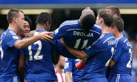 Didier Drogba is carried off by his team-mates as he is substituted.