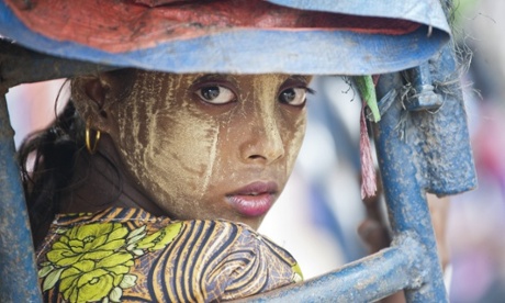 An ethnic Rohingya Muslim woman looking back as she rides a tuk tuk near a camp set up outside the city of Sittwe in Burma's Rakhine state