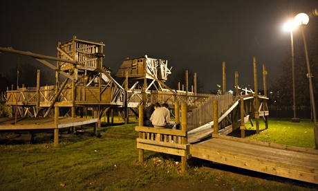 Two teenagers sit outside in the adventure playground at a youth work session at The Arc in the Park