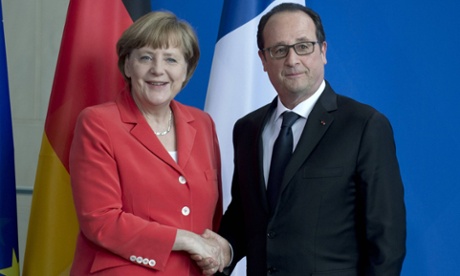Angela Merkel and François Hollande shake hands in Berlin.