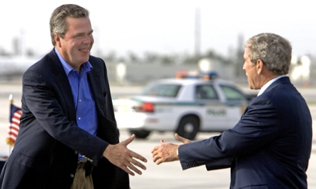 US President George W. Bush (R) reaches out to greet his brother, Governor Jeb Bush, as he arrives at Miami International Airport 30 July, 2006.