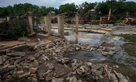 Cement stilts surrounded by rubble and water
