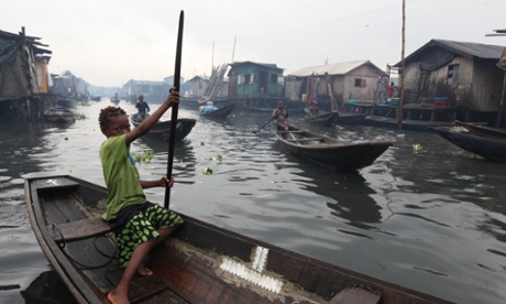 A young girl pilots a canoe in the floating slum of Makoko in Lagos, Nigeria. The country has one of the lowest rates of taxation, losing potential funds for development.