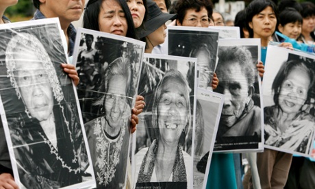 Protesters in Tokyo hold portraits of Chinese, Philippine, South Korean and Taiwanese former comfort women who were sex slaves for Japanese soldiers during the second world war.