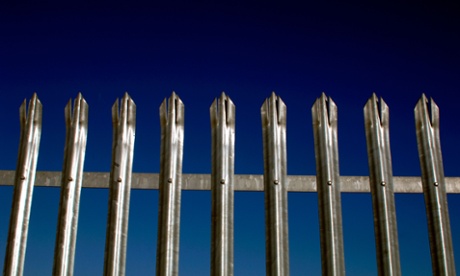 Metal fence against a blue sky.