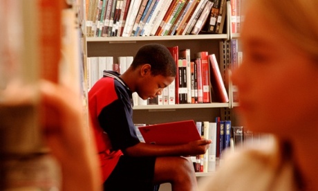 A boy reading in a Library.