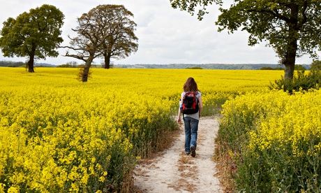 Woman walking along a path in the countryside