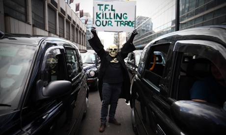 Masked demonstrator in black cab protest