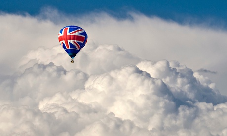 A hot air balloon with a Union flag motif flying in front of dramatic storm clouds