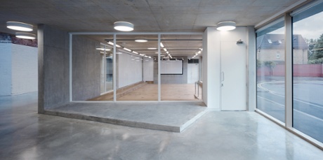 The auditorium opens on to the public atrium and has a glazed wall facing the street.