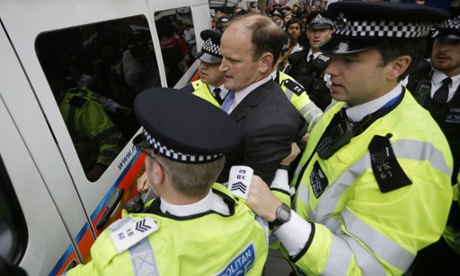 Douglas Carswell is helped into a police van for his own safety in central London on Wednesday.