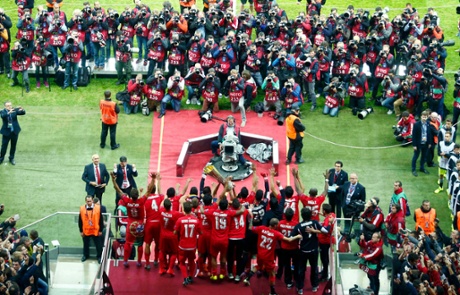 The Sevilla players show off their trophy to the massed ranks of photographers.