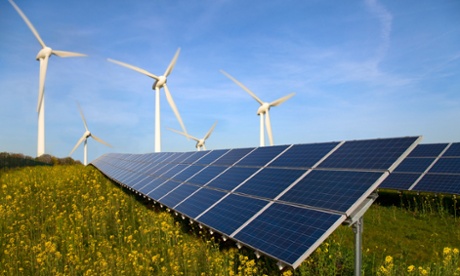 Solar panels and wind turbines in a field