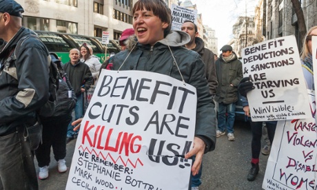 woman with placard saying 'benefit cuts are killing us'