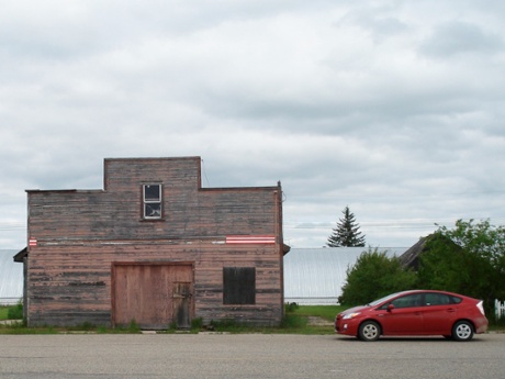 Stopping to photograph and old wooden building near Pipestone, Manitoba.