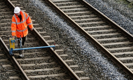 A Network Rail engineer checks railway tracks in Cumbria.