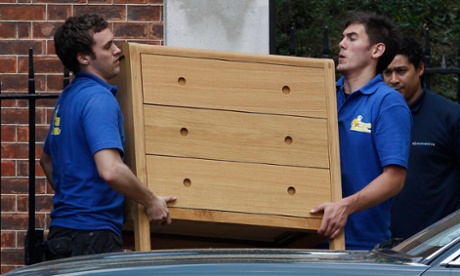 Chest of drawers being carried by removal men
