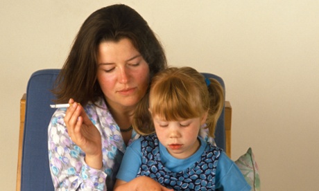 Woman smoking near child