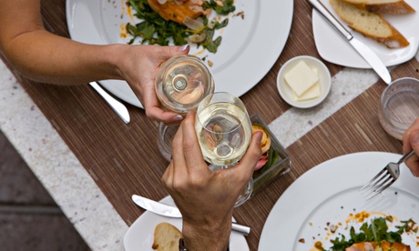 A couple proposing toast with wine glasses