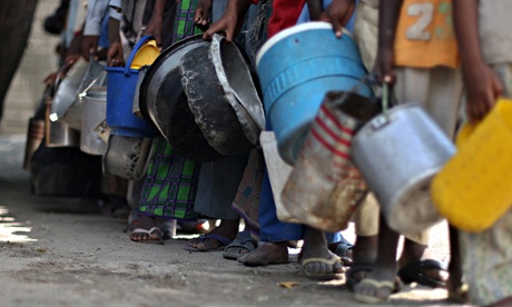 Internally displaced Somali boys queue to receive food aid at a distribution centre funded by the UN agencies and the European Union, in Mogadishu, Somalia, 2009.
