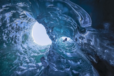 A climber descends into an ice cave, Mendenhall, Alaska.