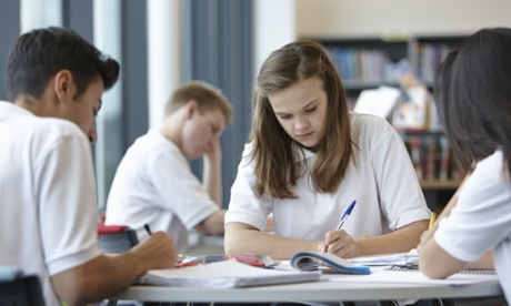 Group of teenagers working in school class