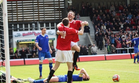 FC United striker Tom Greaves scores the first goal at their new ground, Broadhurst Park, in a test event on 16 May.