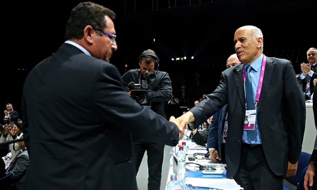 President of the Palestinian FA, Jibril Rajoub, right, shakes hands with Ofer Eini
