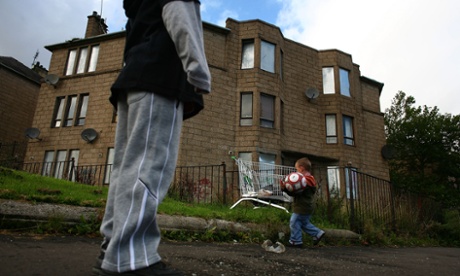 GLASGOW, UNITED KINGDOM - SEPTEMBER 30:  Two young boys play football  in a run down street with boarded up houses, September 30, 2008 in the Govan area of Glasgow, Scotland.