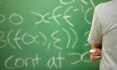 Student working out an equation on a blackboard