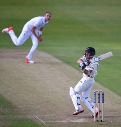 Stuart Broad looks on as Luke Ronchi hits out.