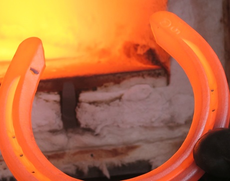 He makes horseshoes from bars of mild steel, heated in the gas-powered forge at the back of his van until they glow.