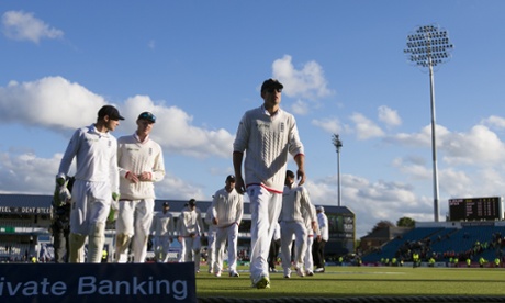 England's captain Alastair Cook leads his team from the pitch after close of play.